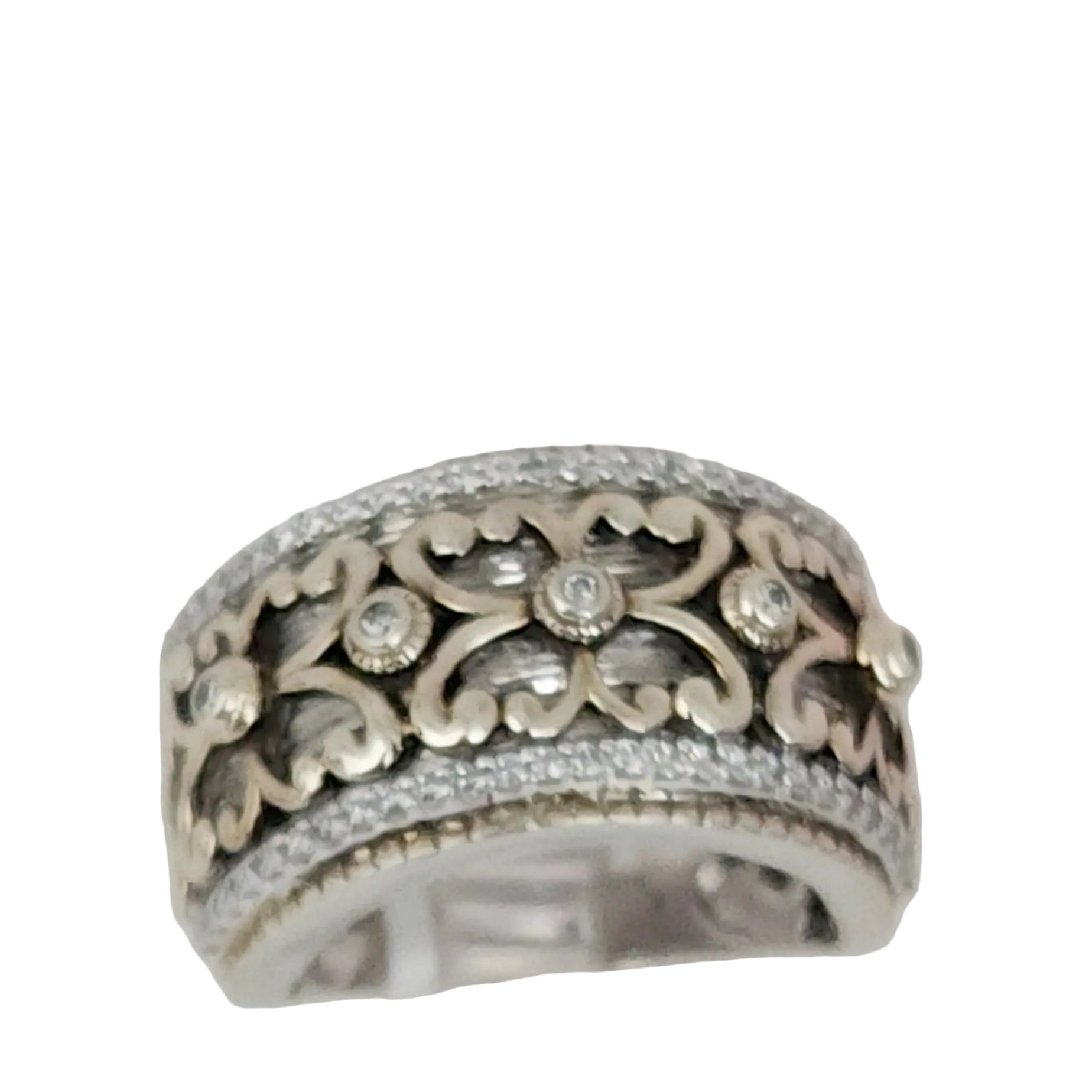 A Sterling Silver and Vermeil estate ring with a wide band and adorned with Cubic Zirconia, displayed on a clear surface.