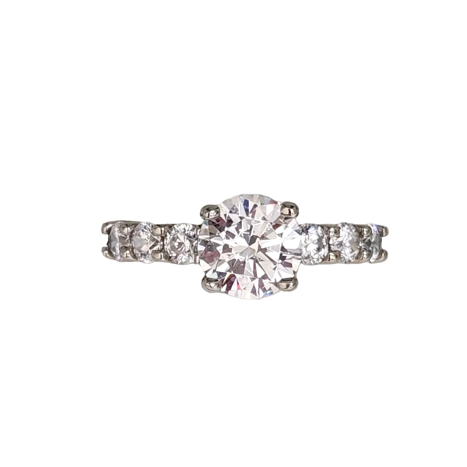 A Sterling Silver ring with a clear cubic zirconia center stone and round zirconia accents on the sides.