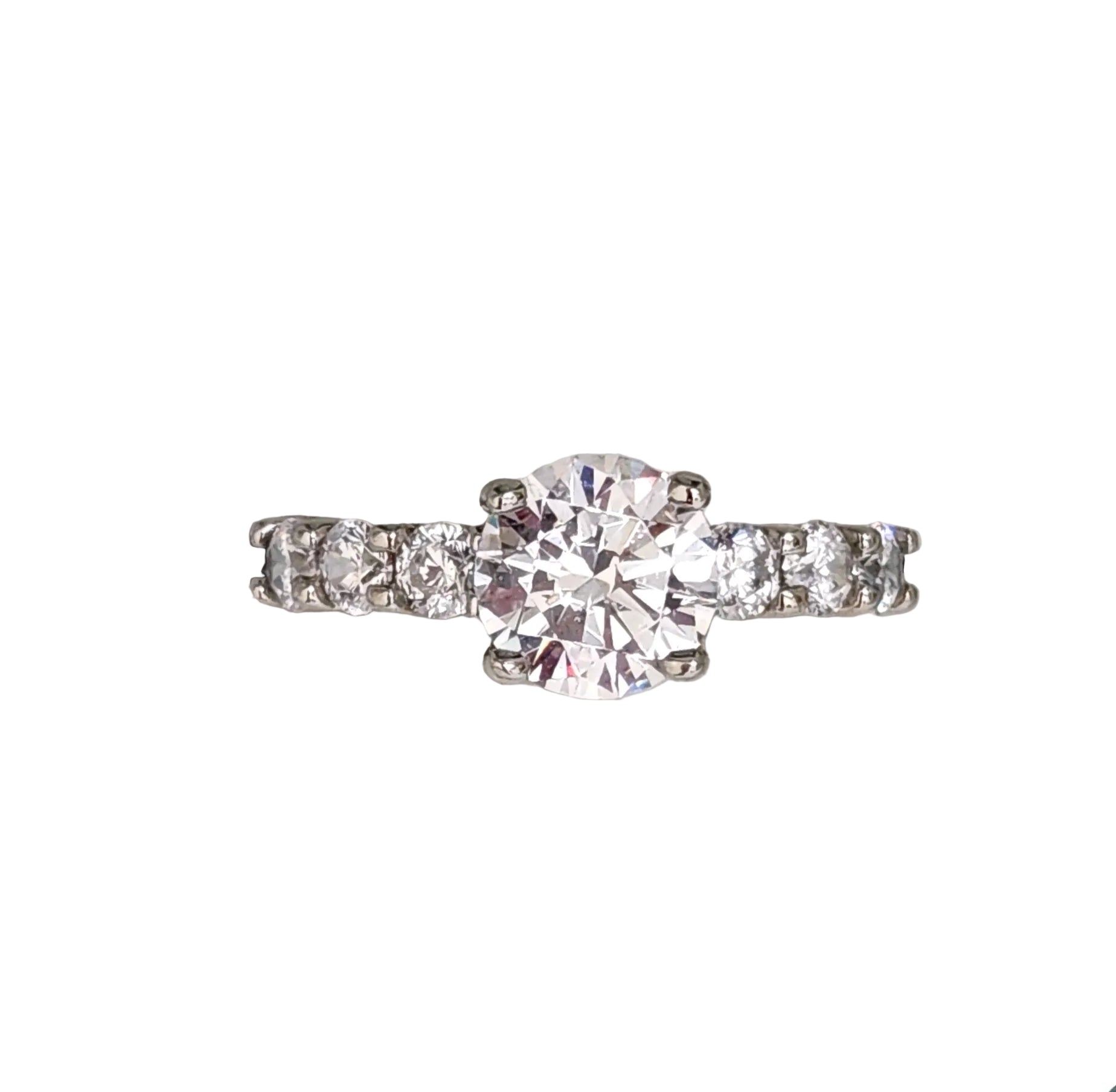 A Sterling Silver ring with a clear cubic zirconia center stone and round zirconia accents on the sides.