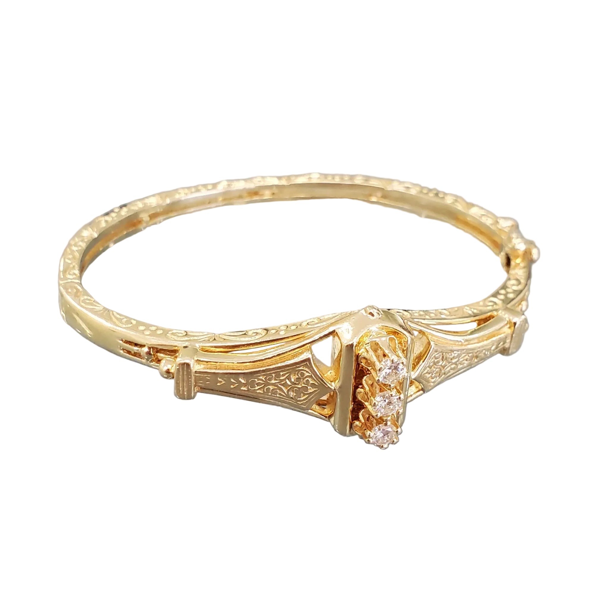 A 14K yellow gold Victorian style bangle bracelet with intricate engravings and three round diamonds totaling .50 CT.
