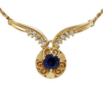 Intricate Gold Necklace Adorned with Diamonds and a Blue Sapphire