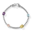 Our Sterling Silver Origin Box Chain Gemstone Bracelet in Sea features five segments of 3.7mm Box Chain and multi sized and cut Amethyst, Olive Quartz, Rose Quartz and Sky Blue Topaz gemstones, set ha