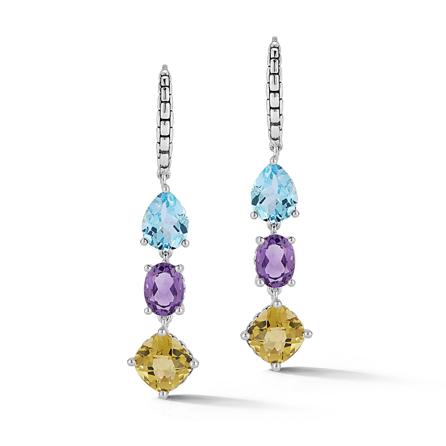 Our Sterling Silver Multi Gemstone Dangle Earrings in Sea feature pear Sky Blue Topaz, oval Amethyst and cushion Olive Quartz. The gemstone trio dangles from Lever Backs decorated with Box Chain patte