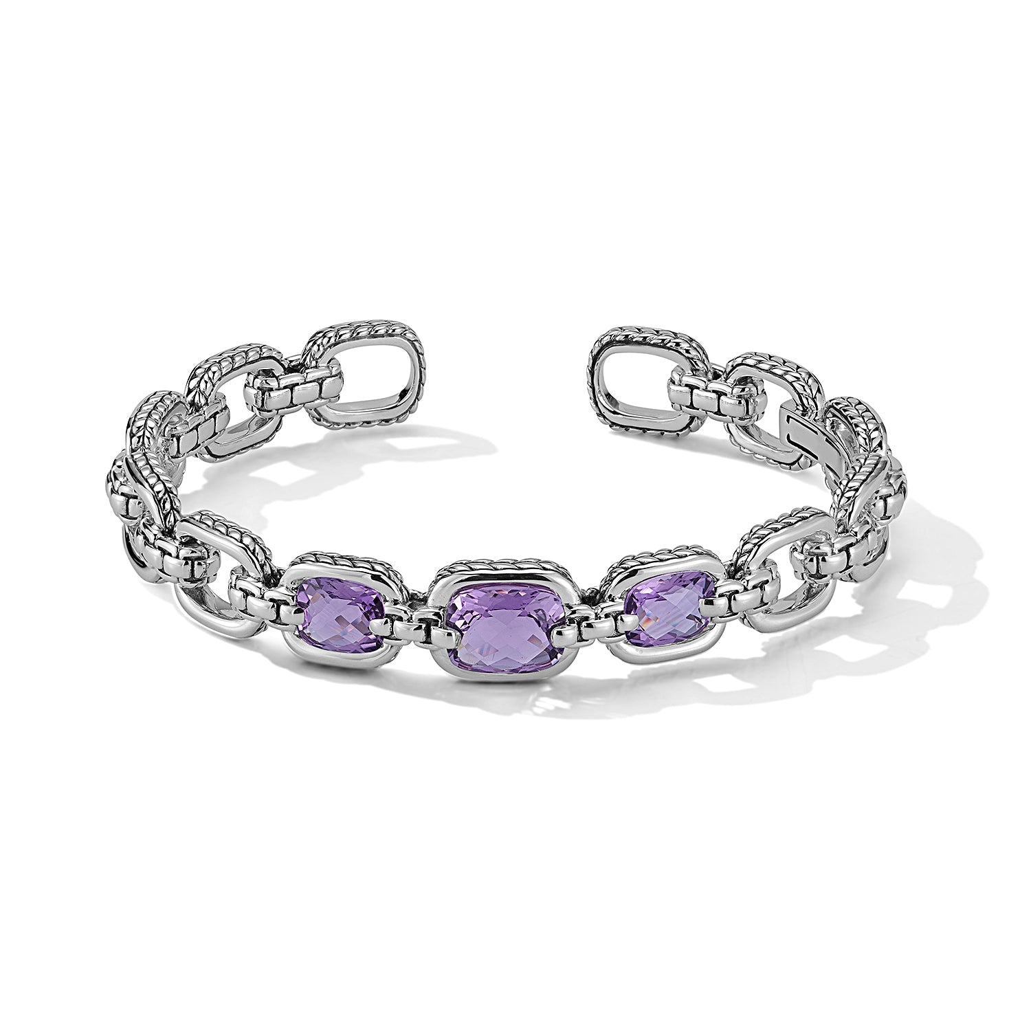 Our Sterling Silver Statement Link Hinged Cuff Bangle showcases three 10x8mm cushion Amethyst gemstones. Each link is highlighted with Basketweave pattern and is bridged with Box Chain. Cuff opening i